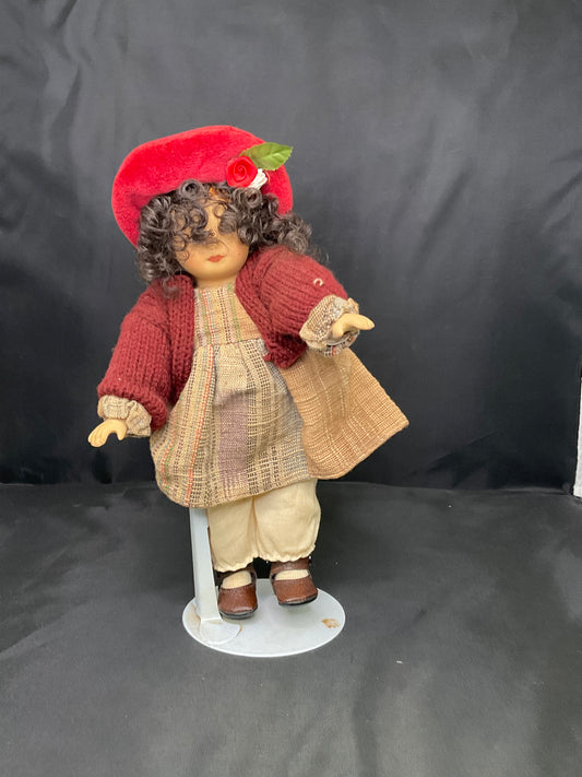 Vintage Porcelain Doll With a Red Beanie and Coat