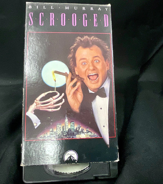 VHS tape of 'Scrooged' with Bill Murray on a black background