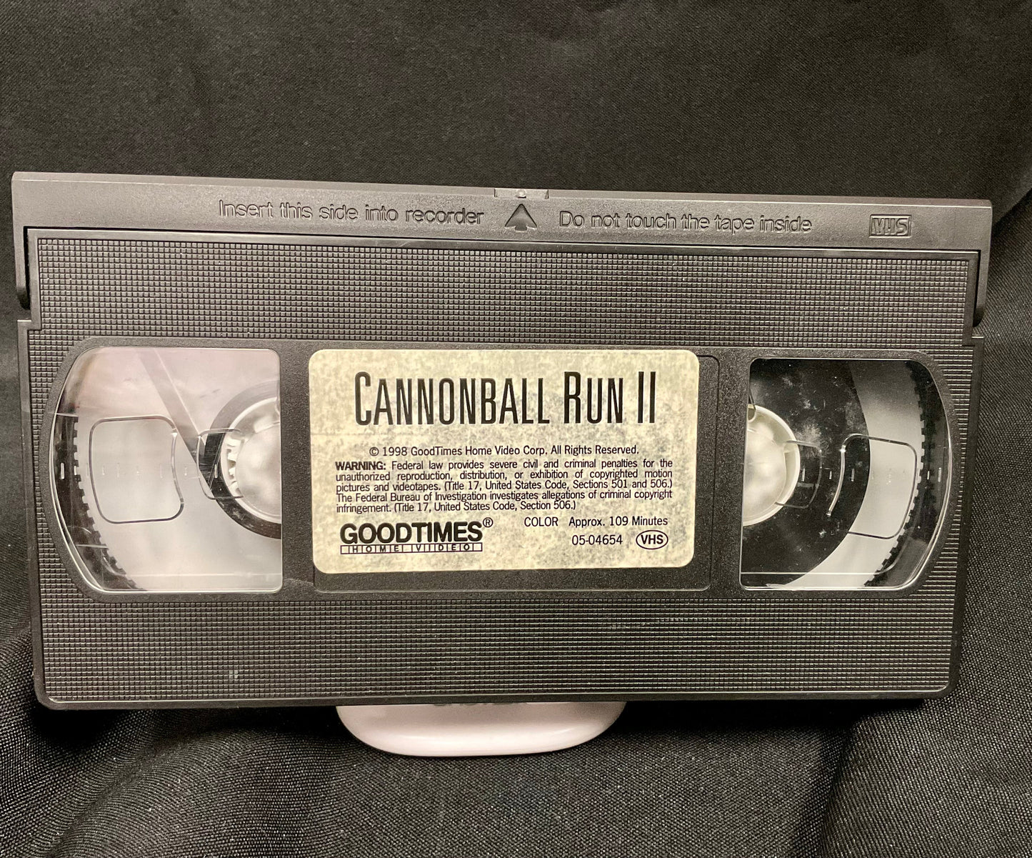 VHS tape of 'Cannonball Run II' with 'Goodtimes' branding on a dark background