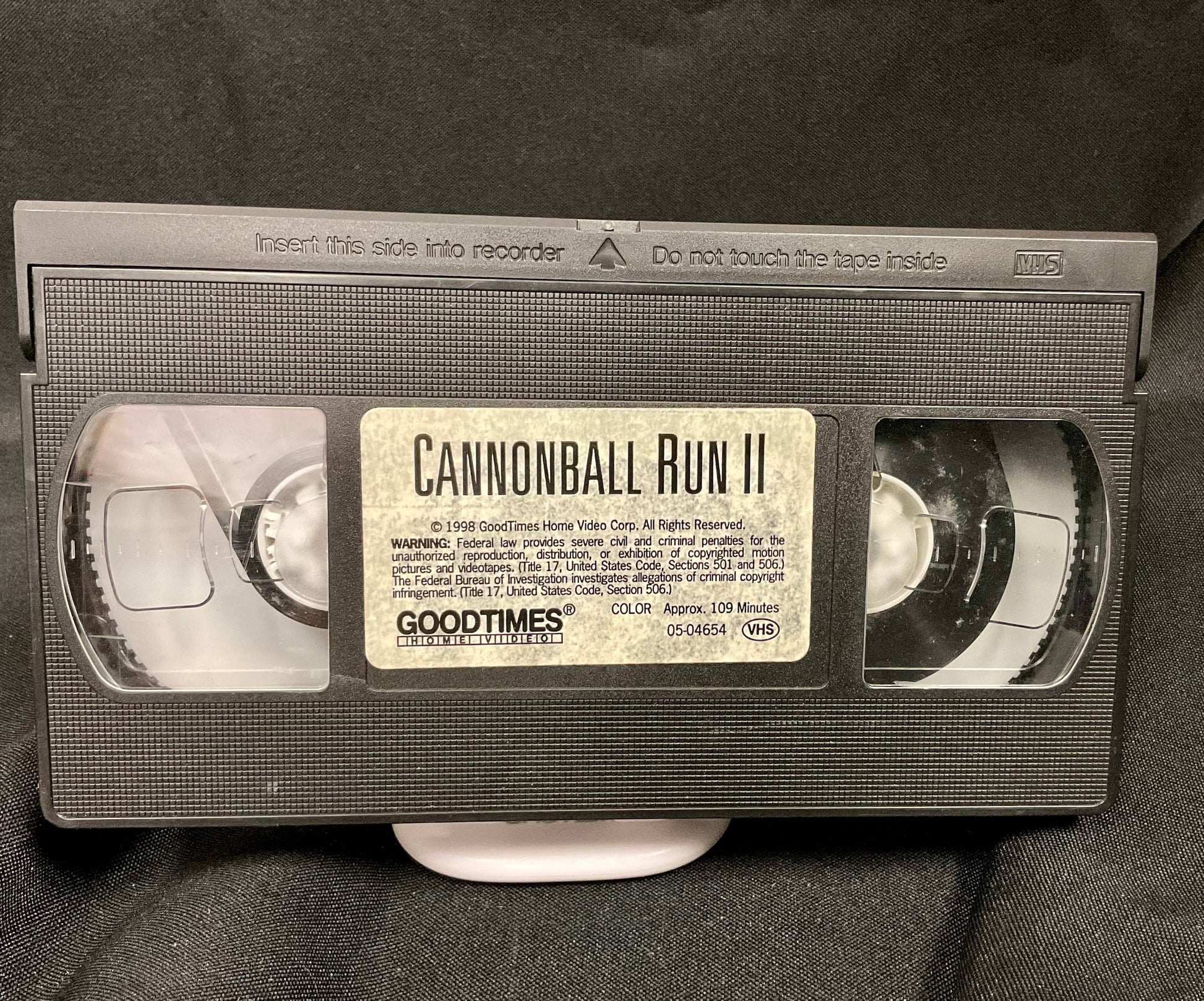 VHS tape of 'Cannonball Run II' with 'Goodtimes' branding on a dark background