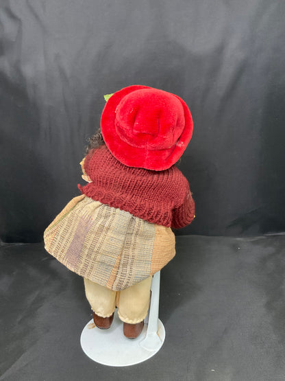 Vintage Porcelain Doll With a Red Beanie and Coat
