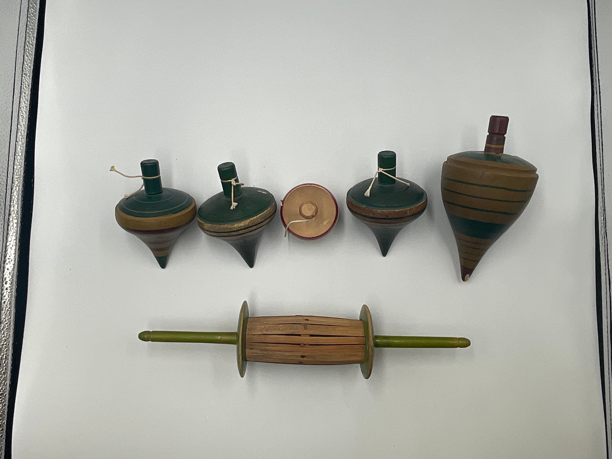 of vintage hand-turned wooden spinning tops