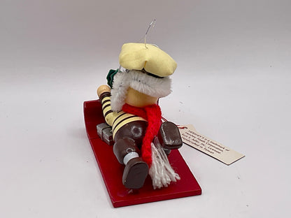 1992 Kurt Adler collectible ornament features a Hershey's-themed chocolate chef sledding on a red toboggan