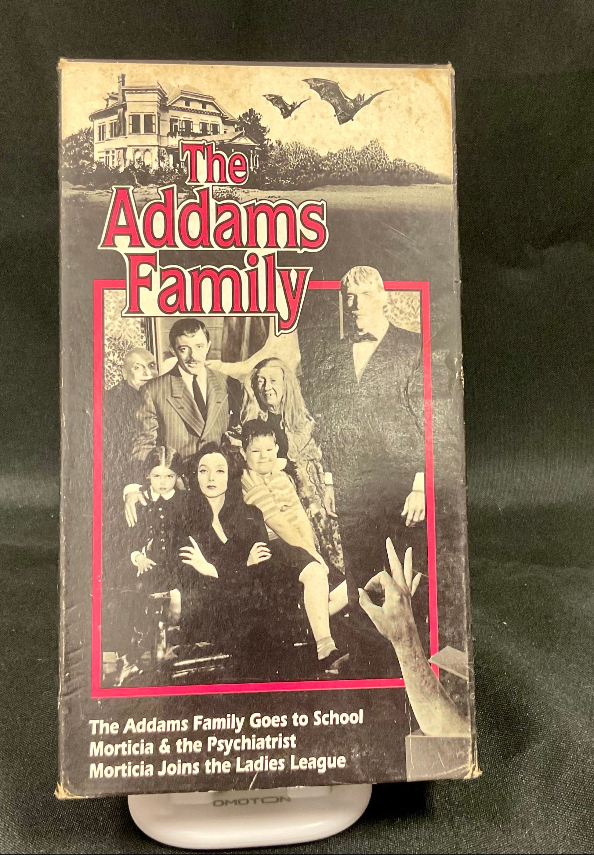 VHS tape cover of 'The Addams Family' with characters and title on a black background