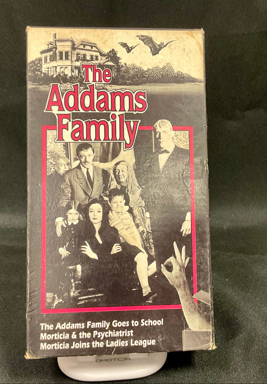 VHS tape cover of 'The Addams Family' with characters and title on a black background