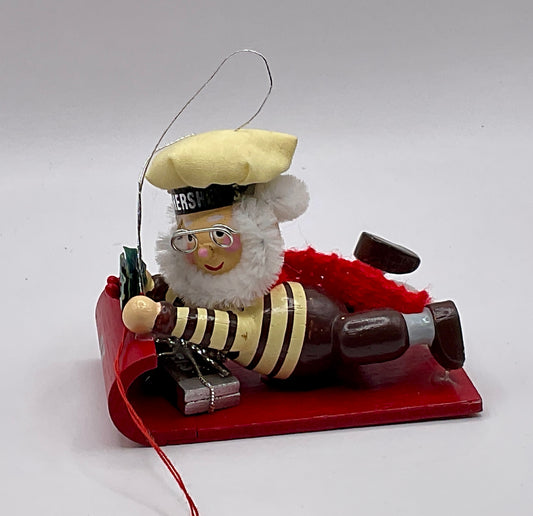 1992 Kurt Adler collectible ornament features a Hershey's-themed chocolate chef sledding on a red toboggan