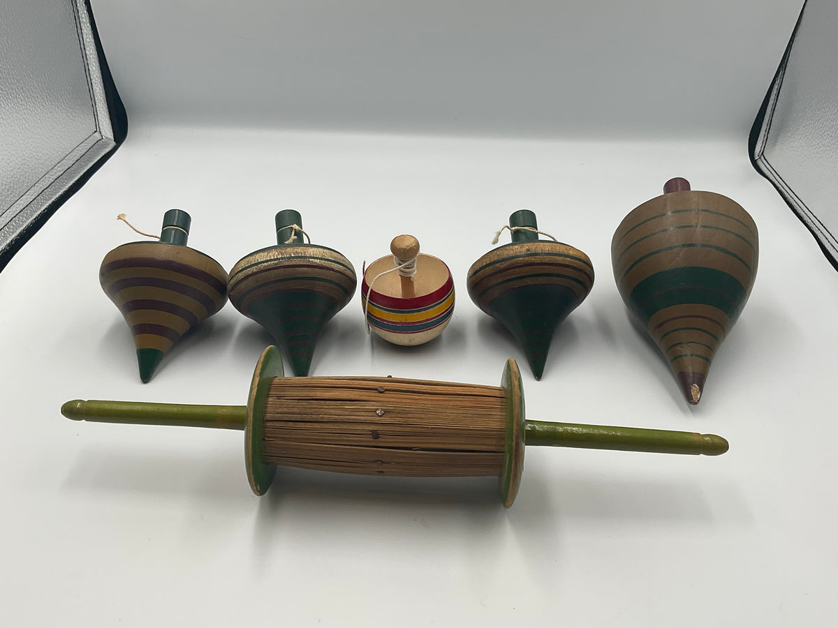 of vintage hand-turned wooden spinning tops