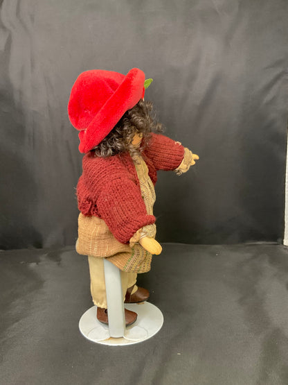 Vintage Porcelain Doll With a Red Beanie and Coat