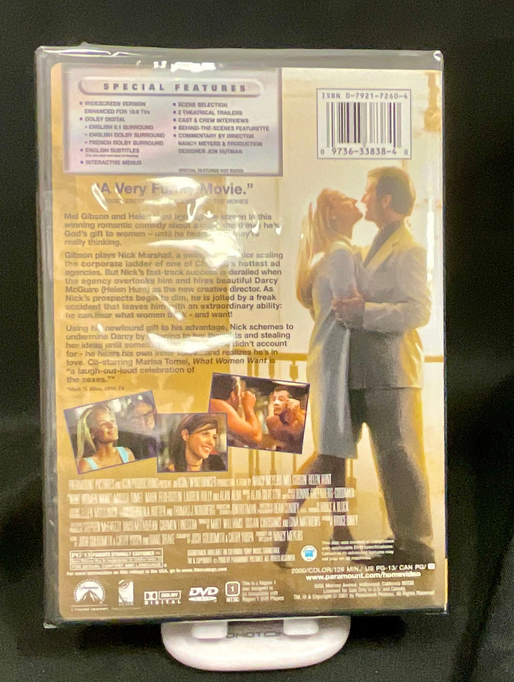 DVD case on a stand with a romantic scene on the cover against a black background