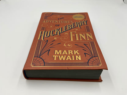 “The Adventures of Huckleberry Finn” by Mark Twain