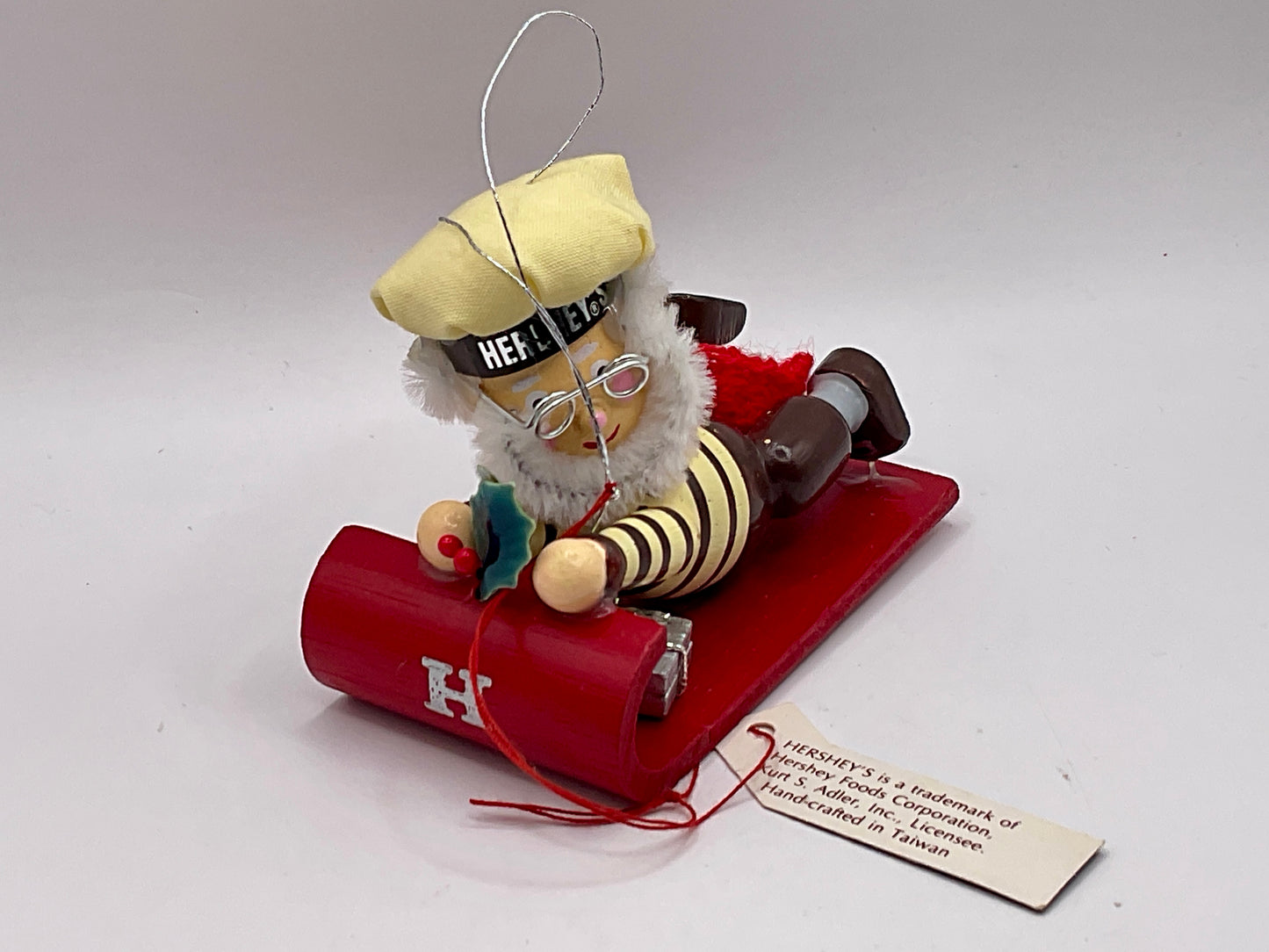 1992 Kurt Adler collectible ornament features a Hershey's-themed chocolate chef sledding on a red toboggan