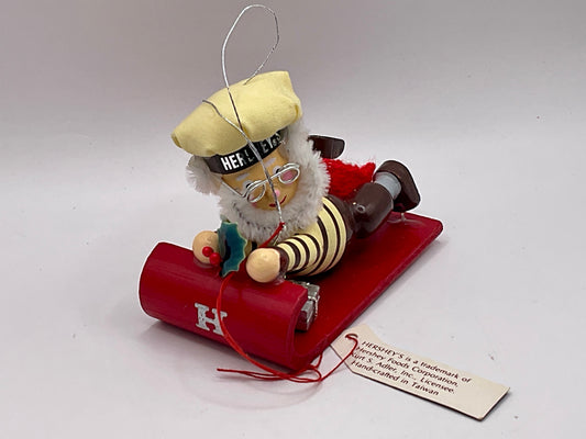 1992 Kurt Adler collectible ornament features a Hershey's-themed chocolate chef sledding on a red toboggan